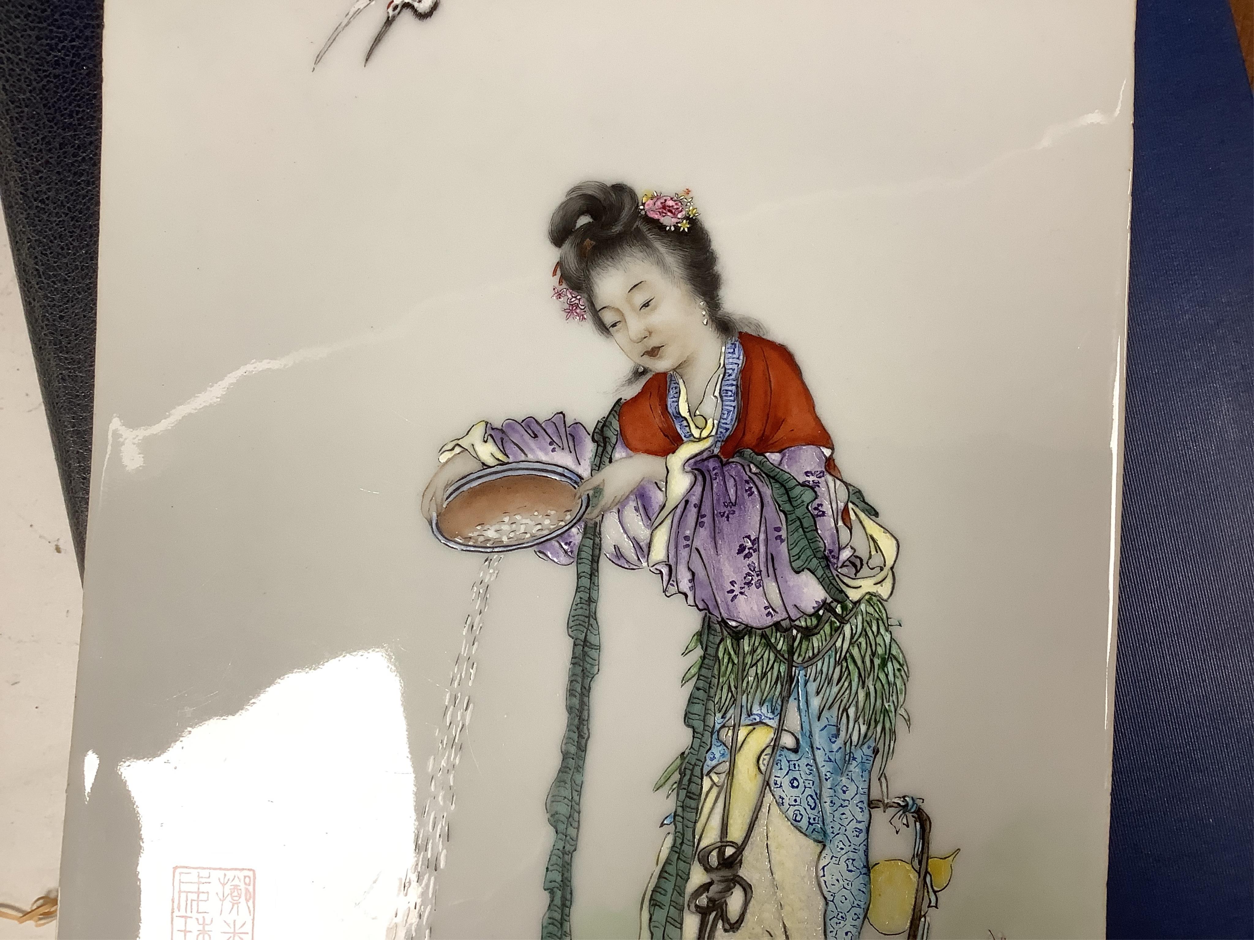 A Chinese famille rose porcelain plaque depicting a woman feeding birds, 36cm high